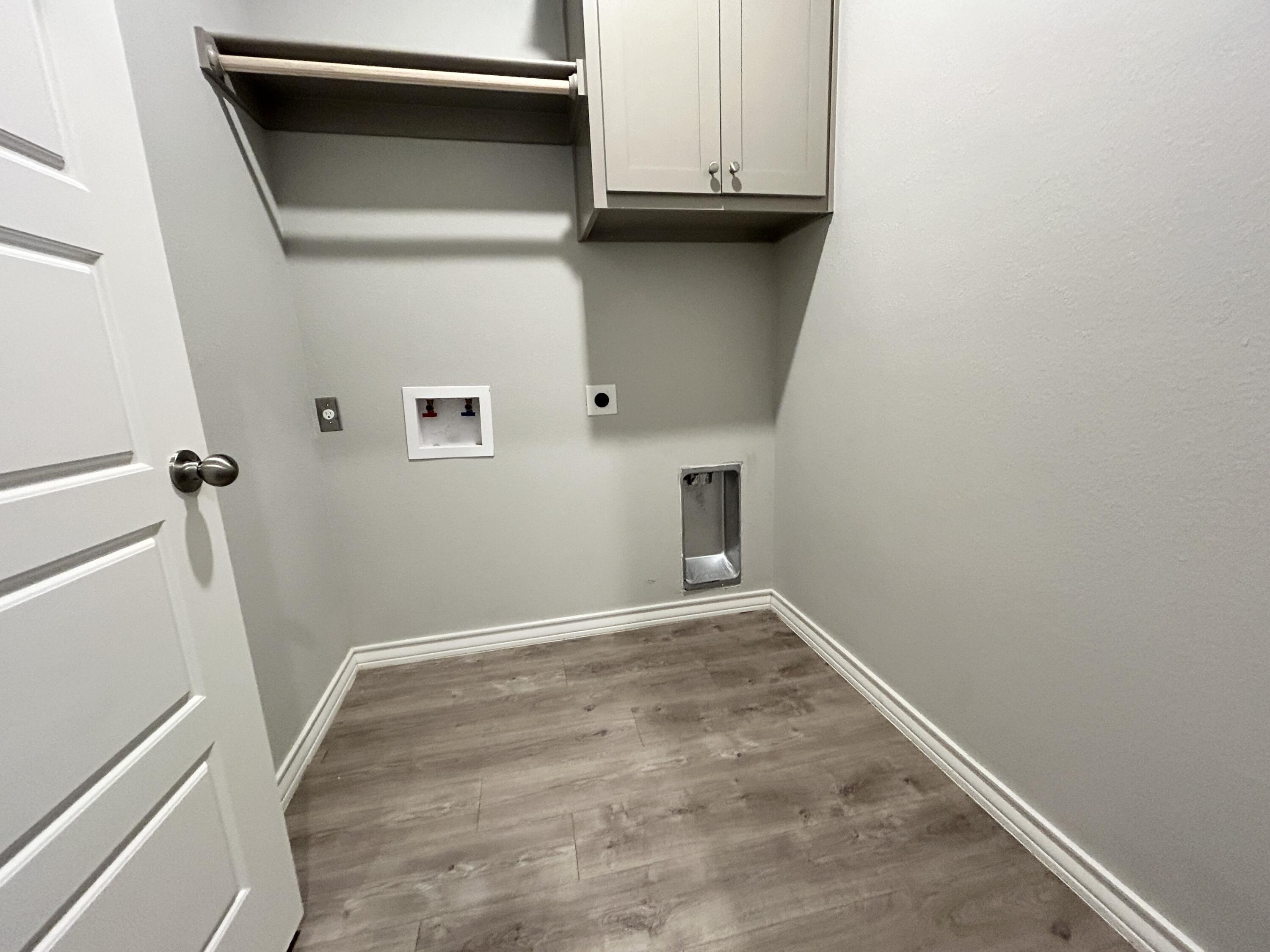 7612 61st Street Lubbock, TX 79407 - Photo 14 of 15 a view of a utility room with cabinets