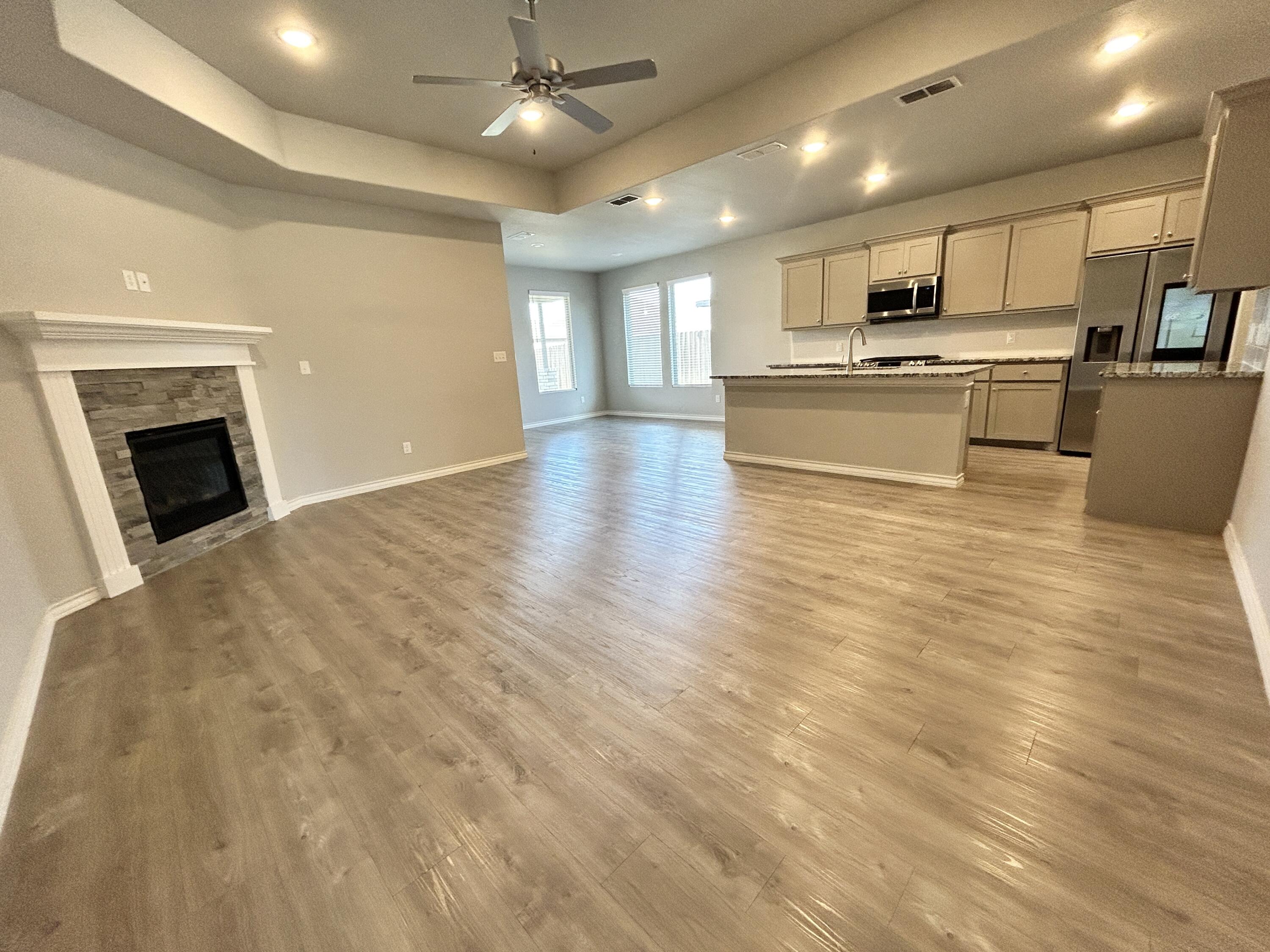 7612 61st Street Lubbock, TX 79407 - Photo 3 of 15 a view of kitchen with cabinets and wooden floor