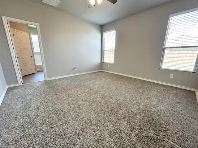 an empty room with windows and closet