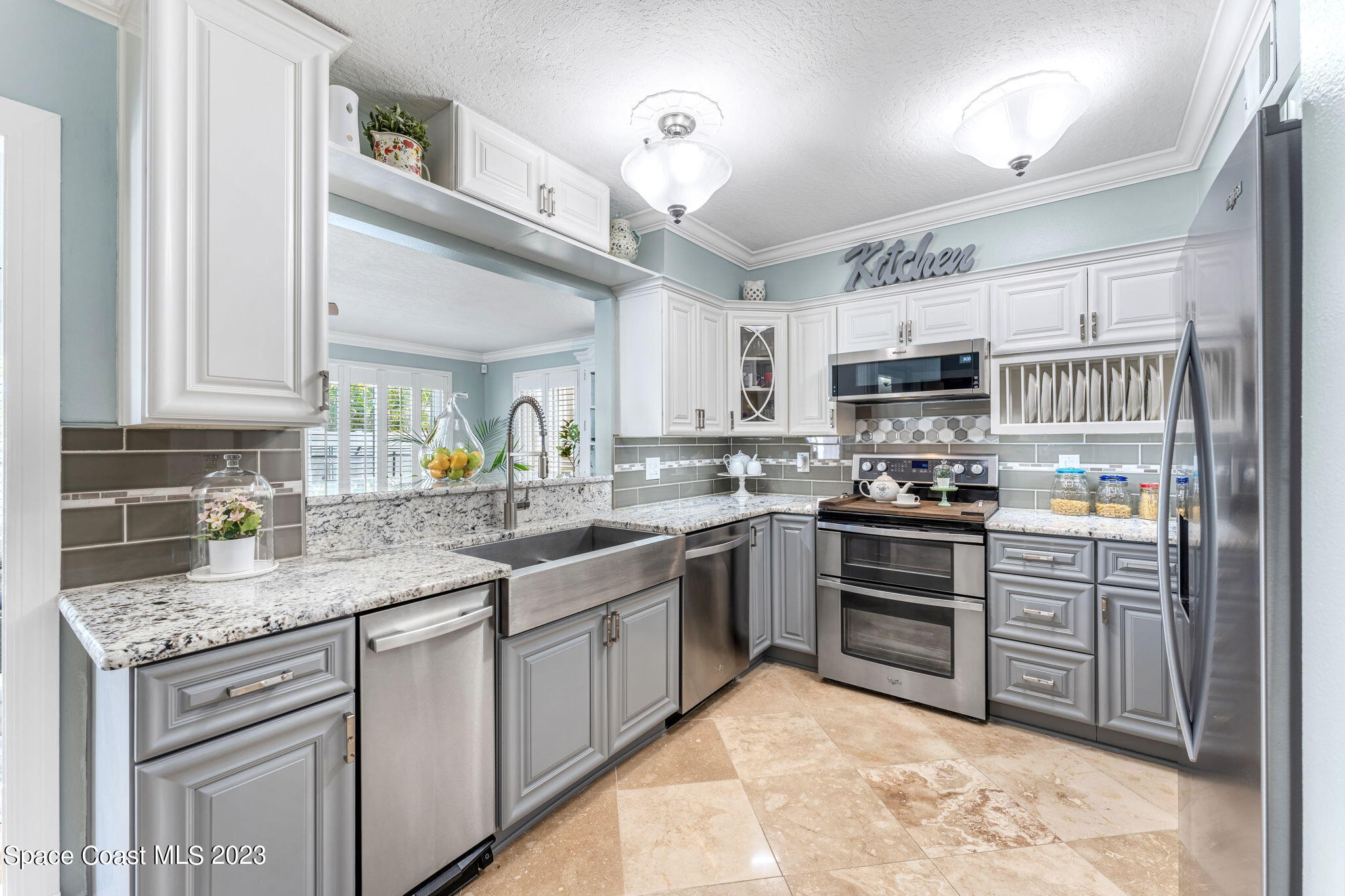 445 9th Avenue Indialantic, FL 32903 - Photo 13 of 62 a kitchen with kitchen island granite countertop a sink counter top space appliances and cabinets