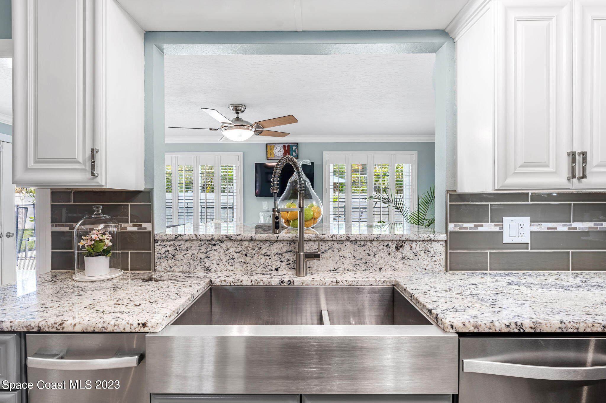 445 9th Avenue Indialantic, FL 32903 - Photo 14 of 62 a kitchen with granite countertop a sink and a stove