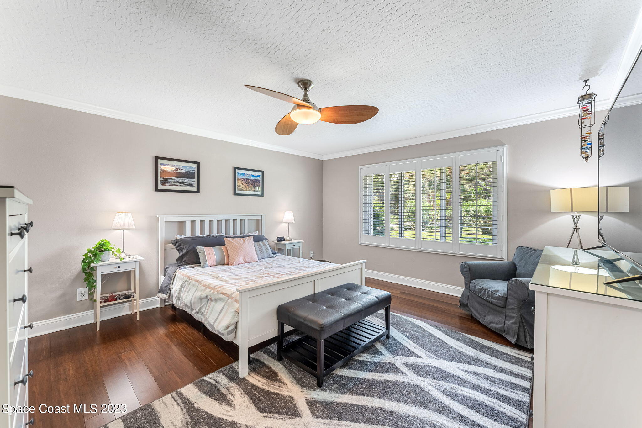 445 9th Avenue Indialantic, FL 32903 - Photo 19 of 62 a bedroom with a bed and a chandelier