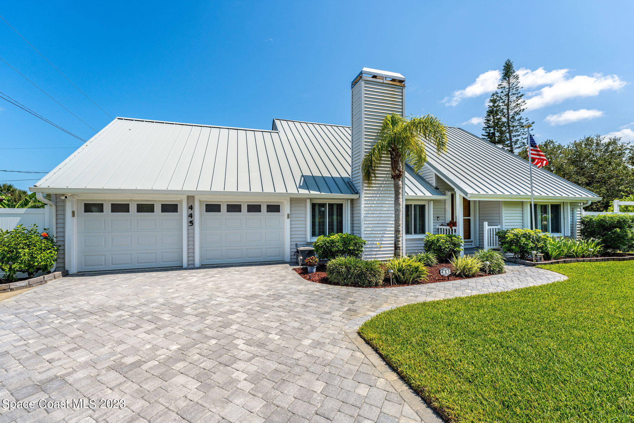 445 9th Avenue Indialantic, FL 32903 - Photo 48 of 62 a front view of a house with a garden and plants