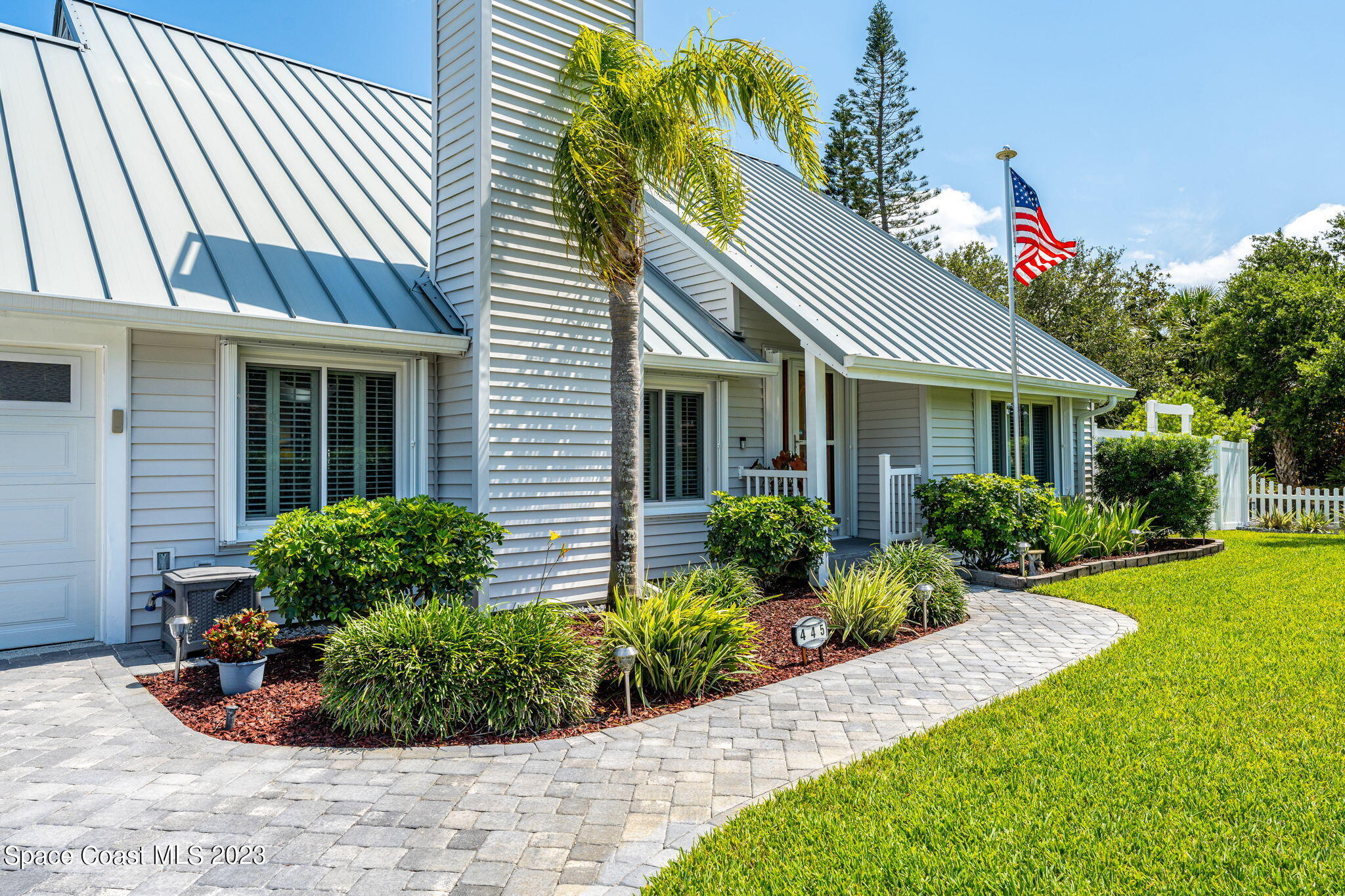 445 9th Avenue Indialantic, FL 32903 - Photo 49 of 62 a front view of a house with garden