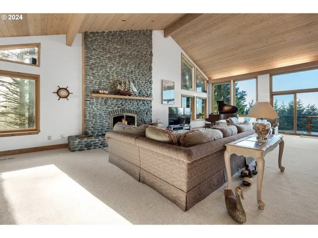 a living room with furniture a large window and kitchen view