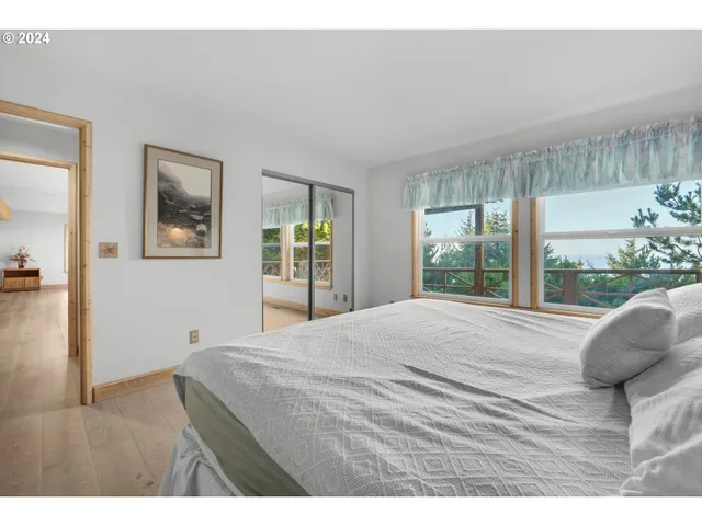 a bedroom with two beds and a desk