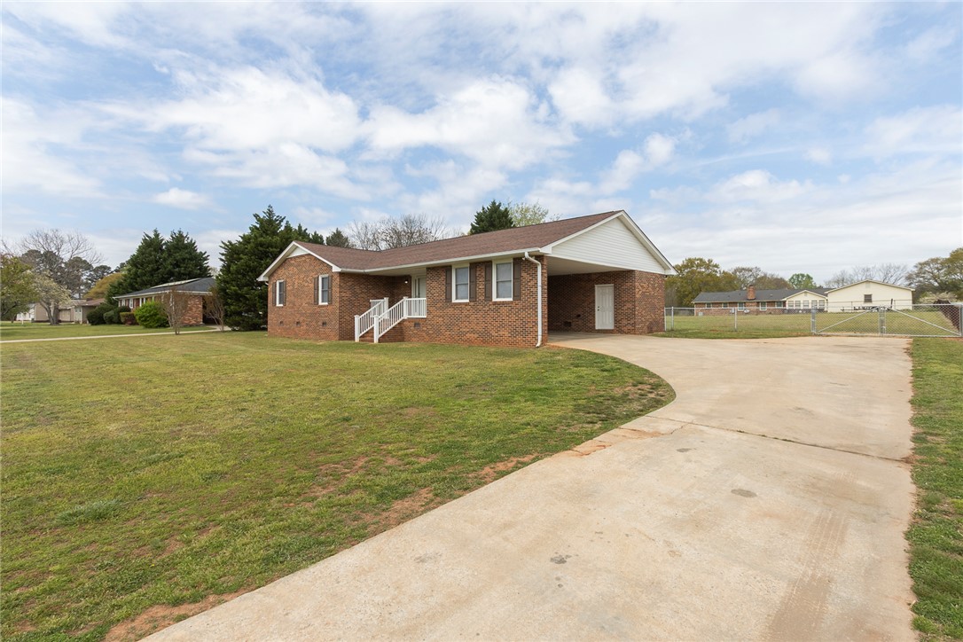 417 Greenmeadow Circle Anderson, SC 29626 - Photo 2 of 41 This classic brick residence features a welcoming entrance and a convenient covered 2 car carport with access to front door and laundry room.