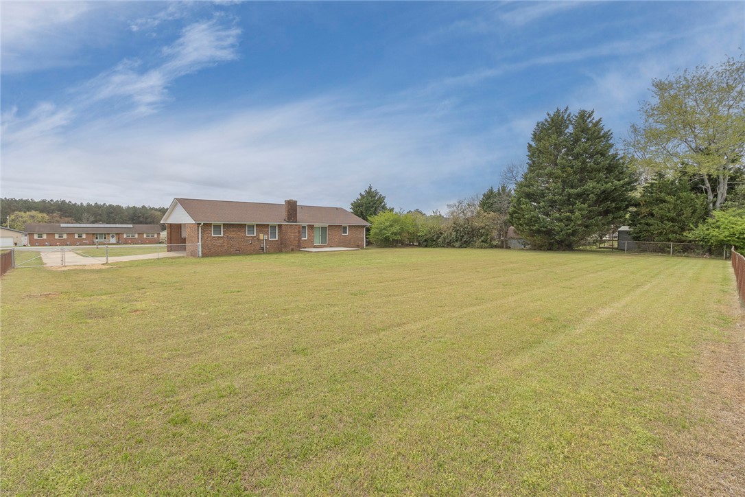 417 Greenmeadow Circle Anderson, SC 29626 - Photo 36 of 41 Expansive outdoor area with a large lawn and a charming brick residence.