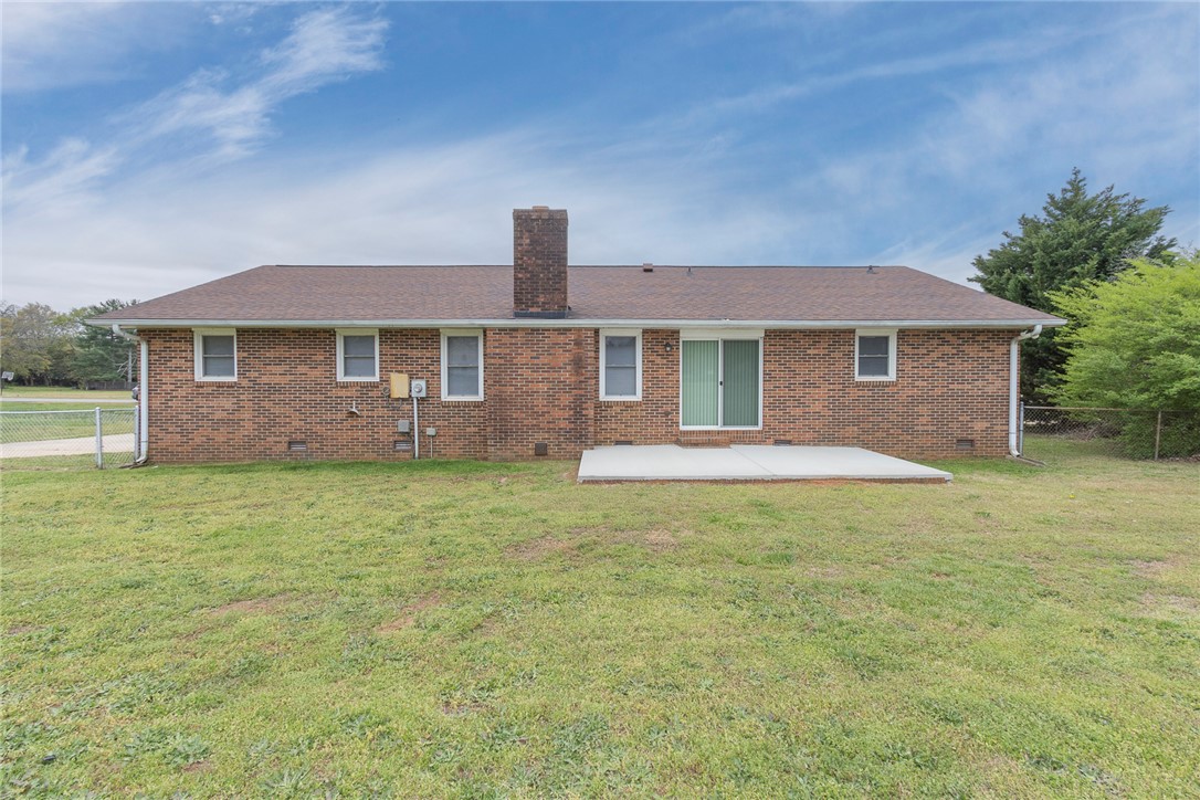 417 Greenmeadow Circle Anderson, SC 29626 - Photo 39 of 41 The rear exterior features brick construction and a spacious lawn, offering outdoor living potential.