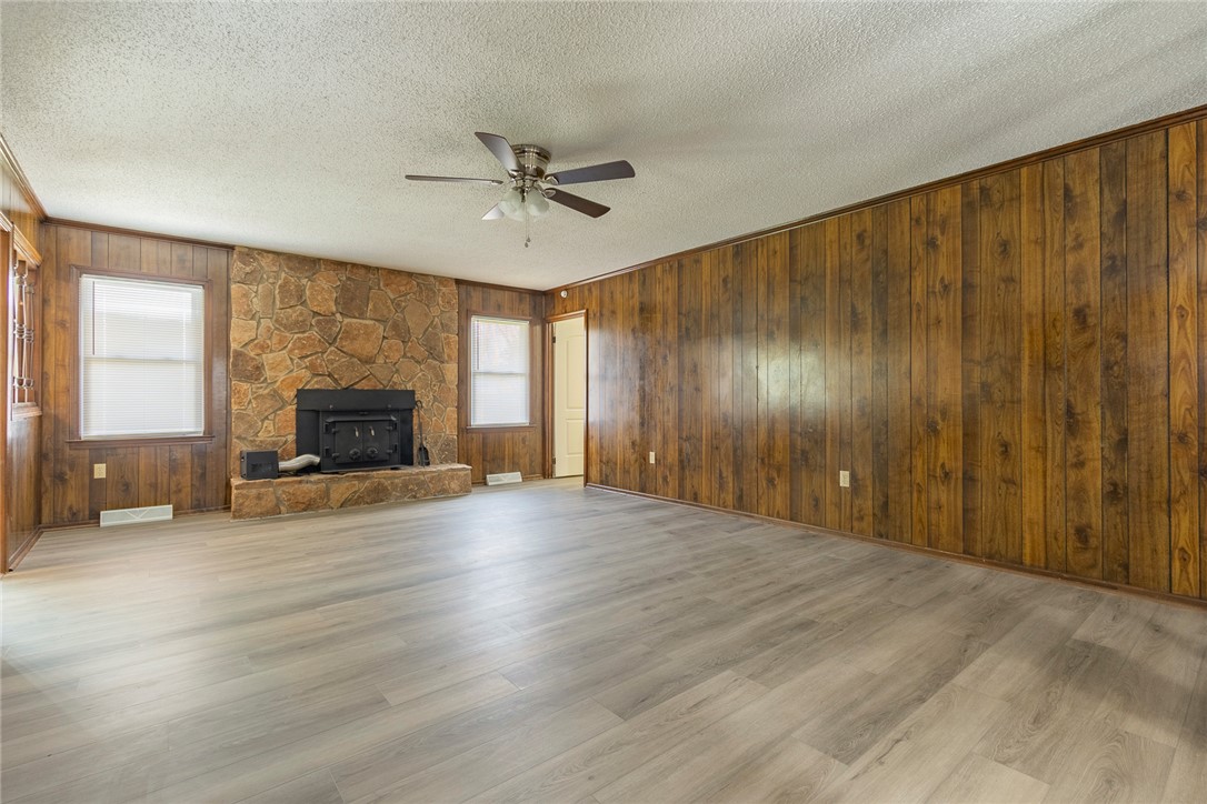 417 Greenmeadow Circle Anderson, SC 29626 - Photo 9 of 41 This inviting room features a stone wood burning fireplace, wood paneling, and durable new LVP flooring.