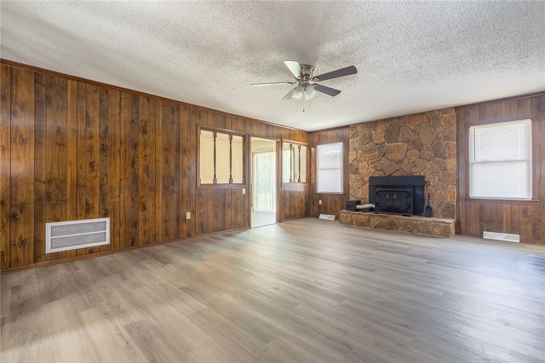 417 Greenmeadow Circle Anderson, SC 29626 - Photo 10 of 41 This spacious living area features wood paneling and a cozy stone fireplace, perfect for gatherings.