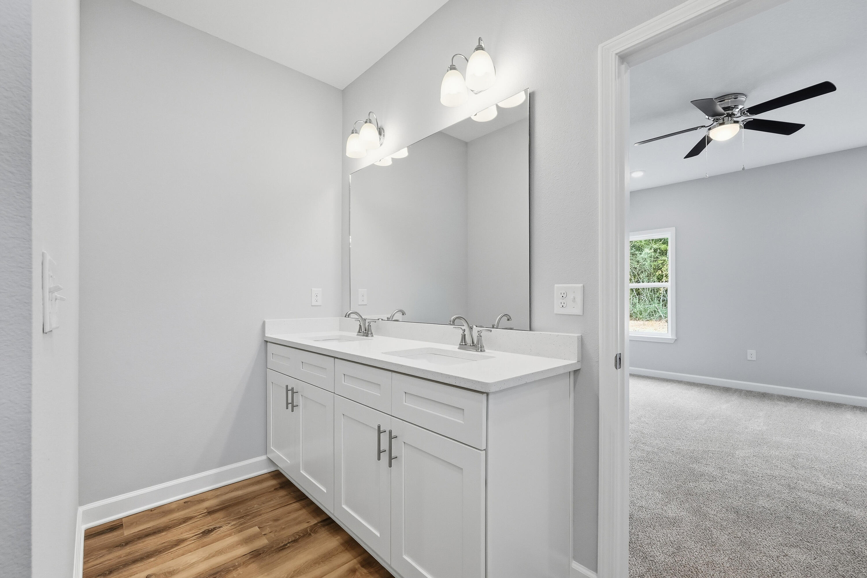 6104 Mildred's Way Crestview, FL 32539 - Photo 12 of 23 a bathroom with a double vanity sink and a mirror