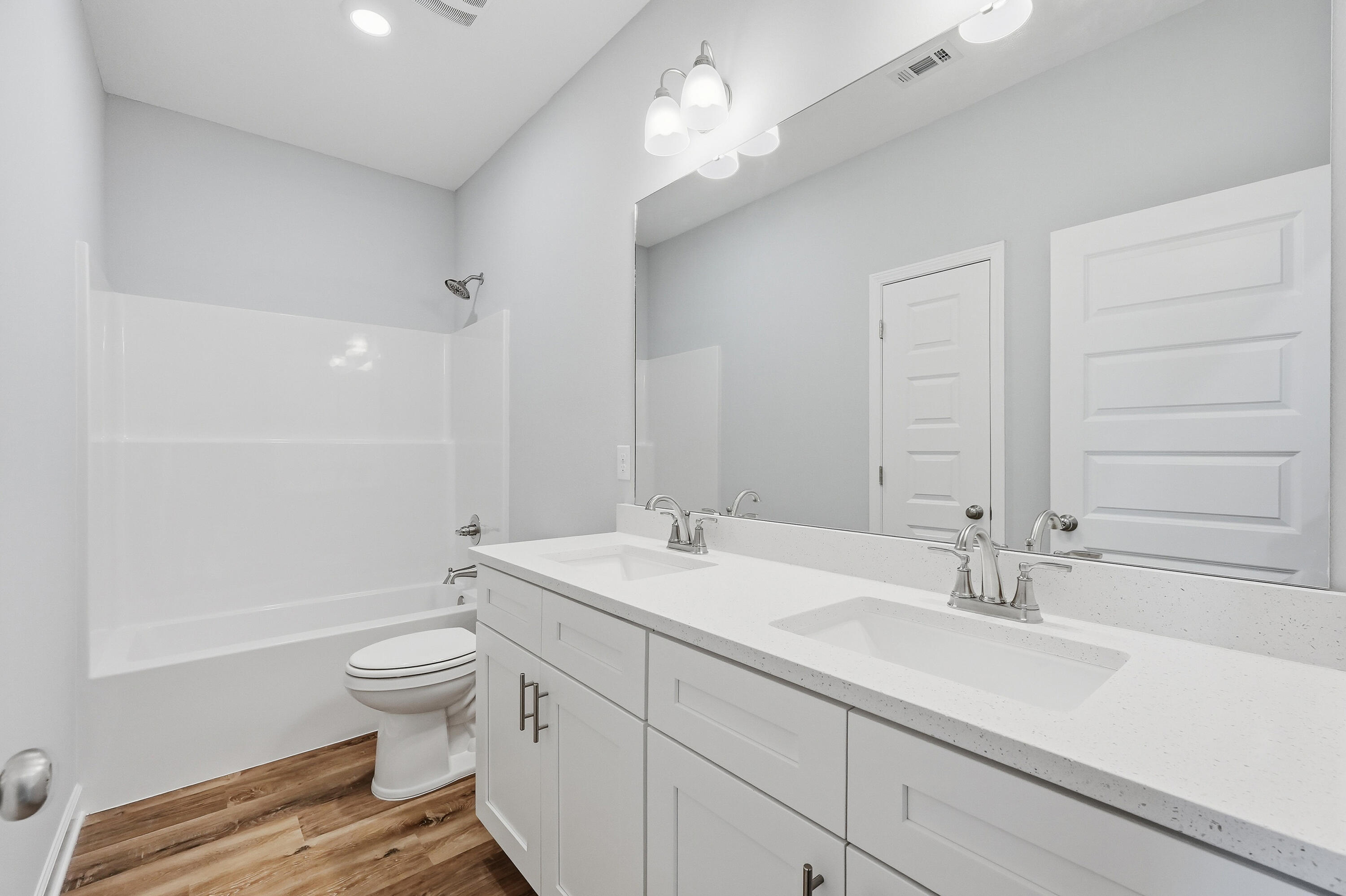 6104 Mildred's Way Crestview, FL 32539 - Photo 16 of 23 a bathroom with a double vanity sink a toilet and a tub