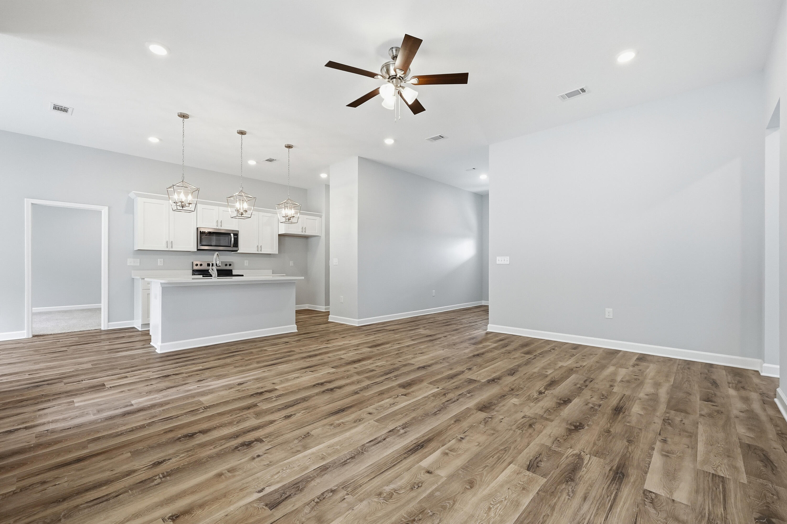 6104 Mildred's Way Crestview, FL 32539 - Photo 5 of 23 a view of a kitchen with a sink and a refrigerator