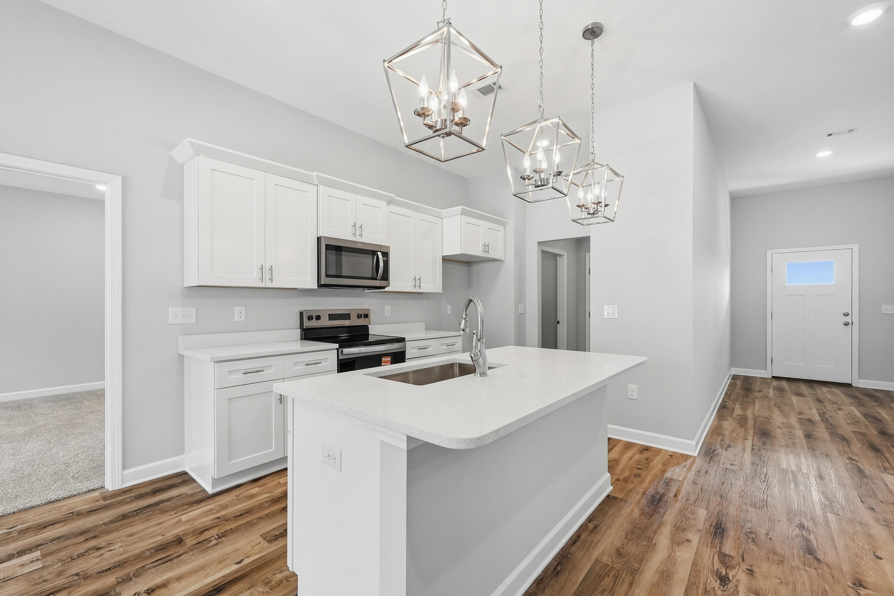 6104 Mildred's Way Crestview, FL 32539 - Photo 8 of 23 a kitchen that has a lot of white cabinets and stainless steel appliances