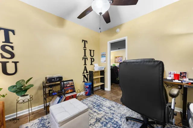 a view of a workspace with furniture and gym equipment