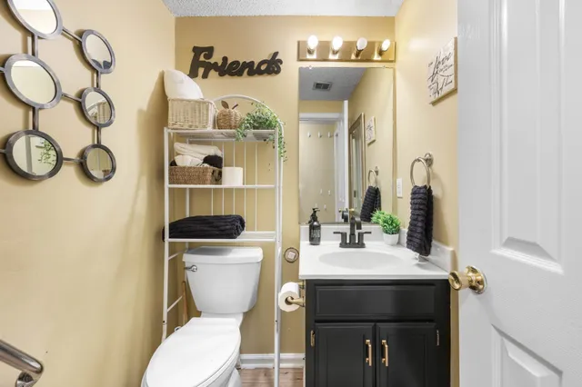 a bathroom with a toilet sink and mirror