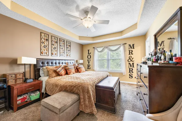 a bedroom with furniture and a large window