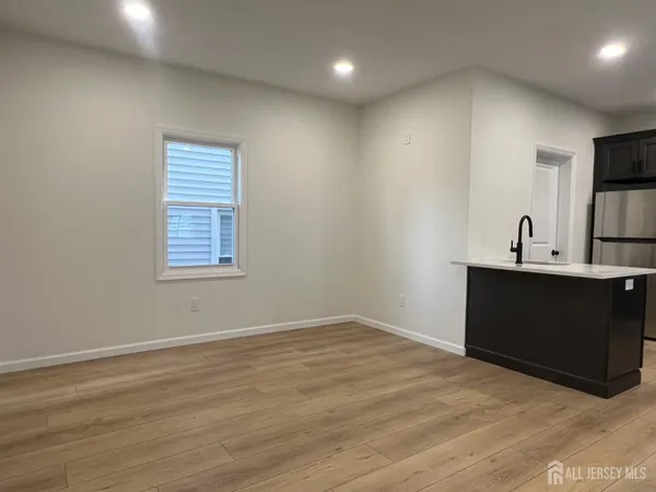 a kitchen with kitchen island stainless steel appliances a sink dishwasher a refrigerator stove and microwave