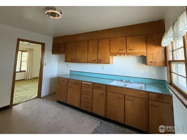 a kitchen with sink and cabinets