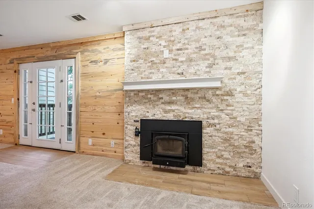 a large living room with stainless steel appliances kitchen island furniture and a fireplace