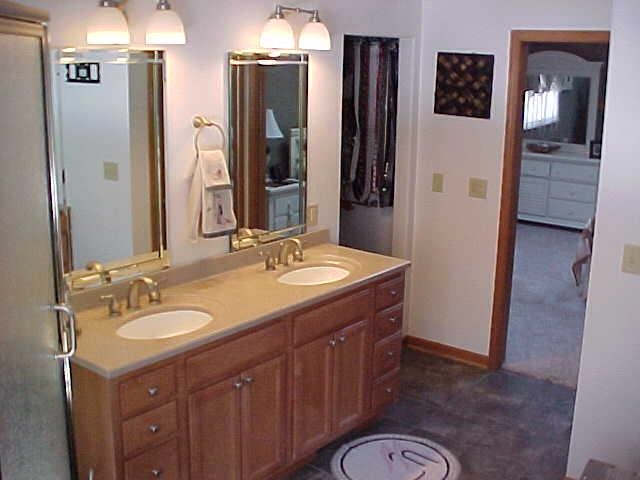 2952 Yale Bridge Road South Beloit, IL 61080 - Photo 11 of 22 a bathroom with a granite countertop sink toilet a mirror a vanity and shower