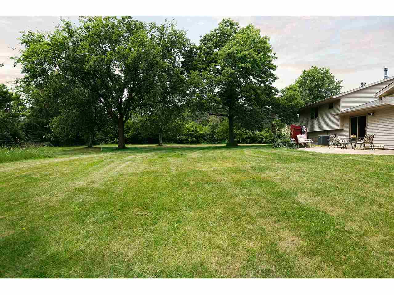 2952 Yale Bridge Road South Beloit, IL 61080 - Photo 20 of 22 a view of a green field with trees in the background
