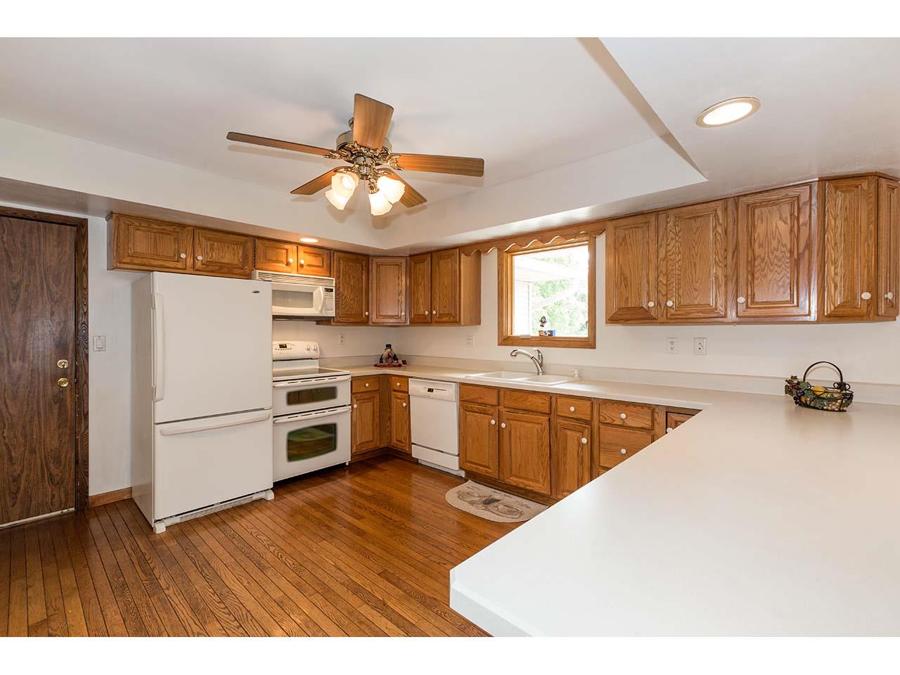 2952 Yale Bridge Road South Beloit, IL 61080 - Photo 4 of 22 a kitchen with stainless steel appliances granite countertop a refrigerator a sink dishwasher a stove with wooden cabinets