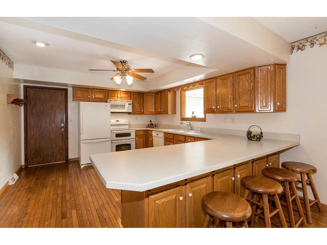 2952 Yale Bridge Road South Beloit, IL 61080 - Photo 5 of 22 a kitchen with stainless steel appliances a refrigerator a sink dishwasher and a stove with wooden floor