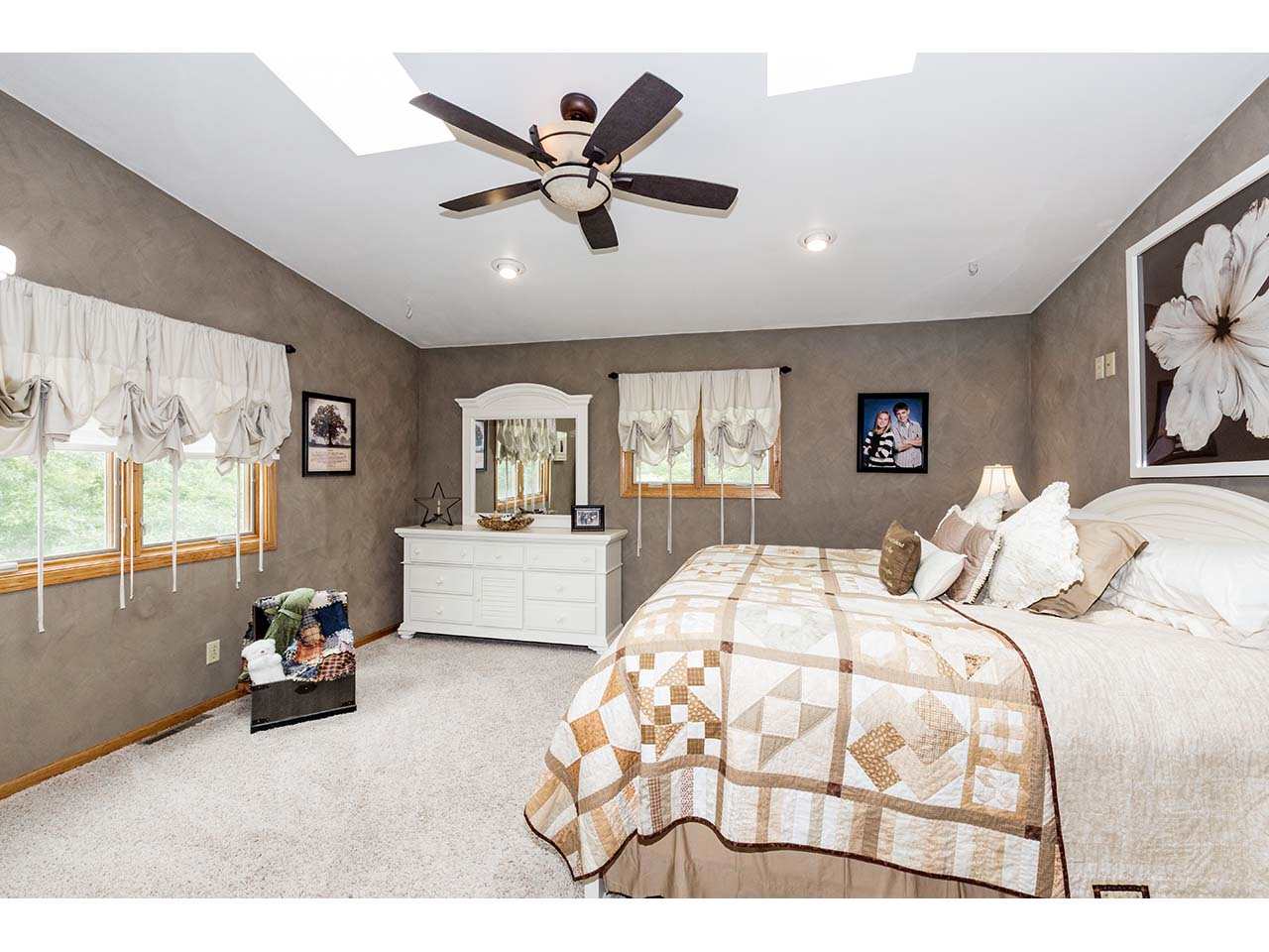 2952 Yale Bridge Road South Beloit, IL 61080 - Photo 9 of 22 a bedroom with a large bed and a chandelier