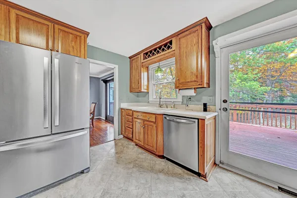 a kitchen with stainless steel appliances granite countertop a refrigerator a sink and a stove