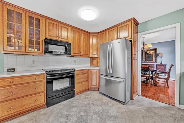 a kitchen with granite countertop stainless steel appliances a refrigerator stove and microwave