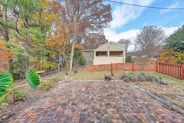 a view of balcony with wooden floor and fence