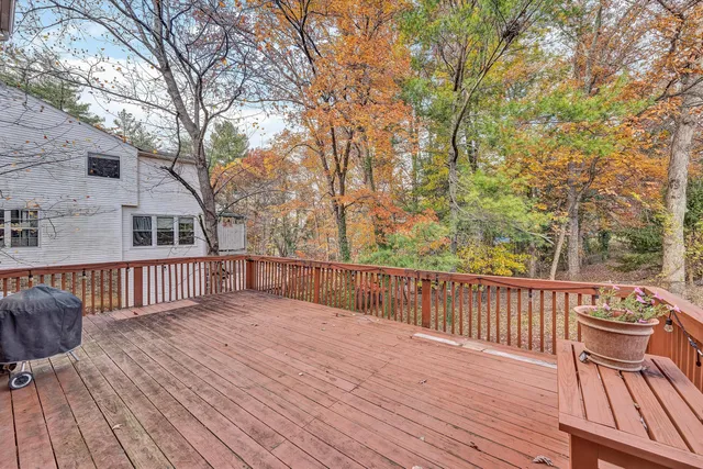 a balcony with wooden floor and furniture