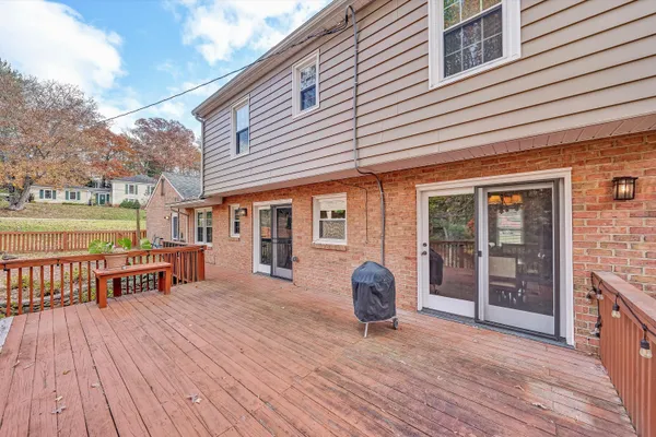 a view of a balcony with wooden floor and fence