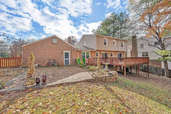a backyard of a house with barbeque oven table and chairs