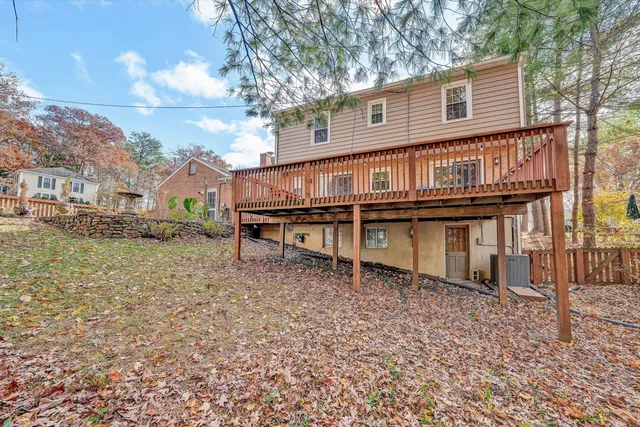 a view of a dry yard with wooden fence