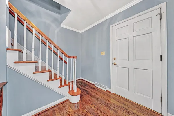 a view of an entryway with wooden floor