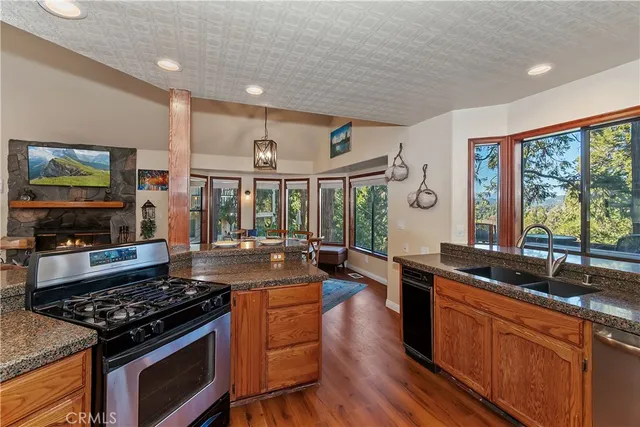 a kitchen with stainless steel appliances granite countertop a stove and a sink