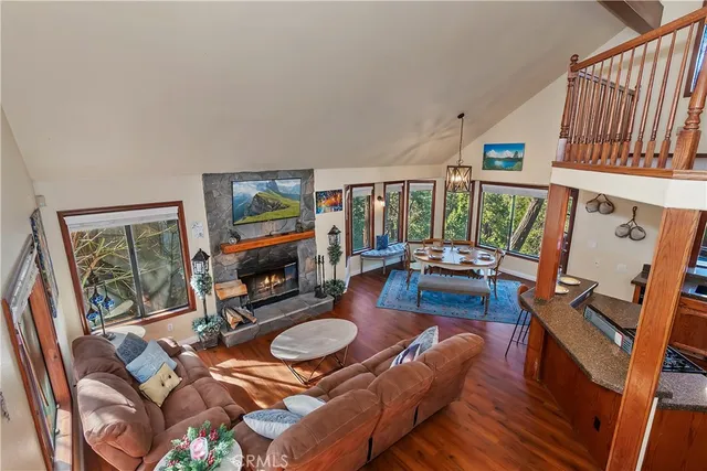 a living room with furniture flat screen tv and a fireplace
