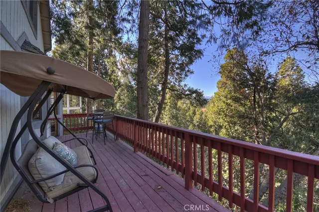 a view of balcony with wooden floor and outdoor seating