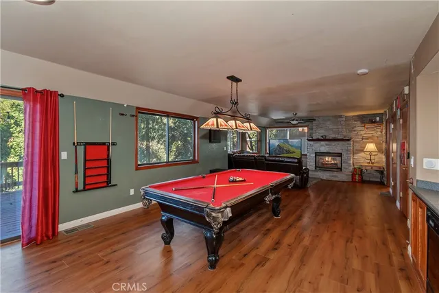 a living room with furniture a ceiling fan and a wooden floor