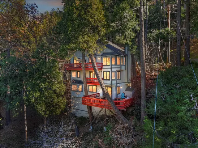 a view of a brick house with a small yard and sitting area