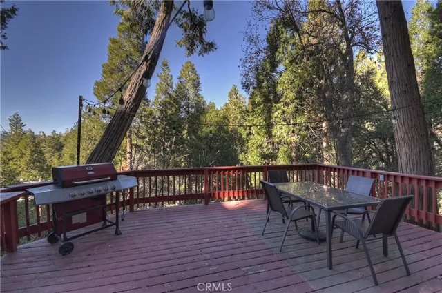 a view of a dinning table and chairs on the roof deck