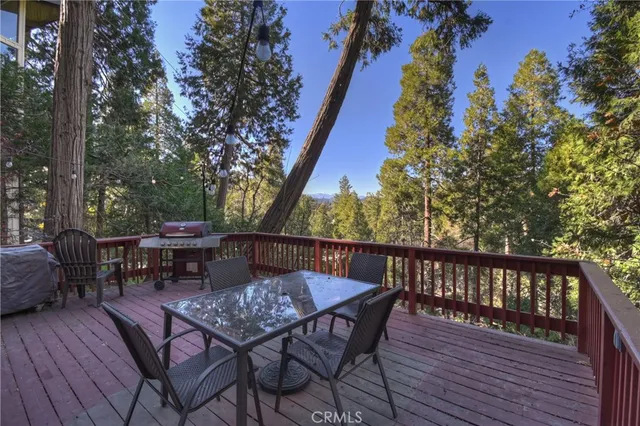 a view of balcony with wooden floor and outdoor seating