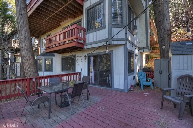 a view of a wooden chairs and table in a patio