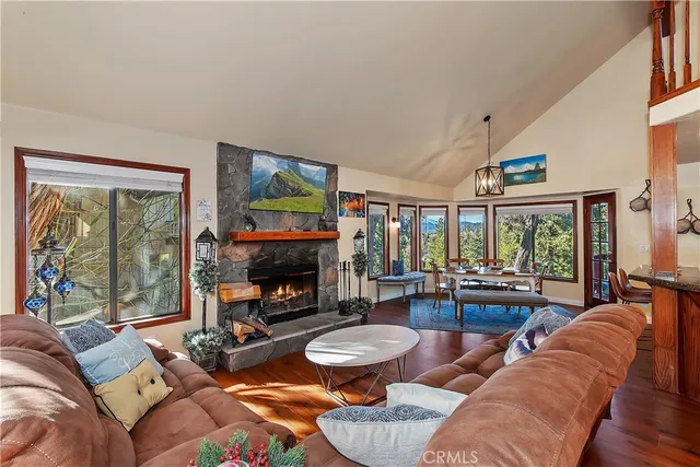 a living room with fireplace furniture and a large window