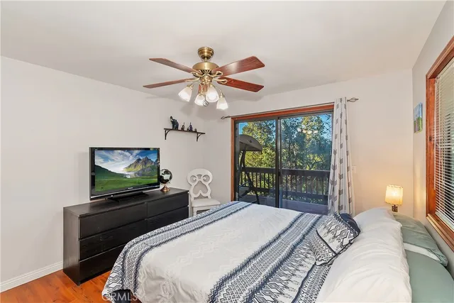 a bedroom with a bed a table and chair