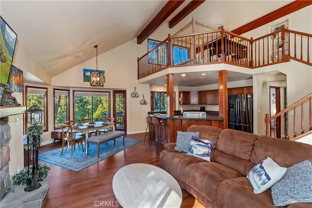 a living room with furniture a window and wooden floor