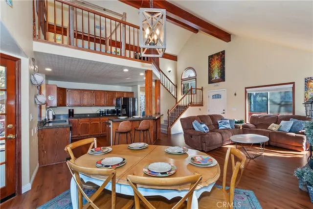 a dinning area with furniture and wooden floor